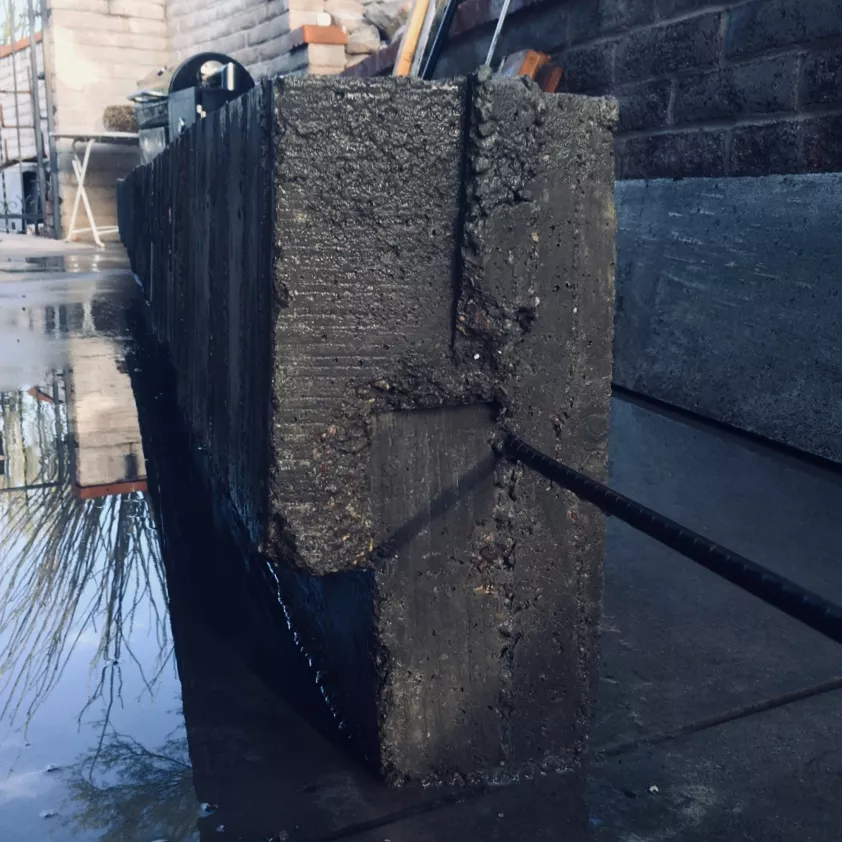 Rough concrete and rebar after a wash.